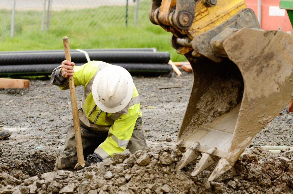 Workers digging hole