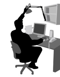 Man at desk with light